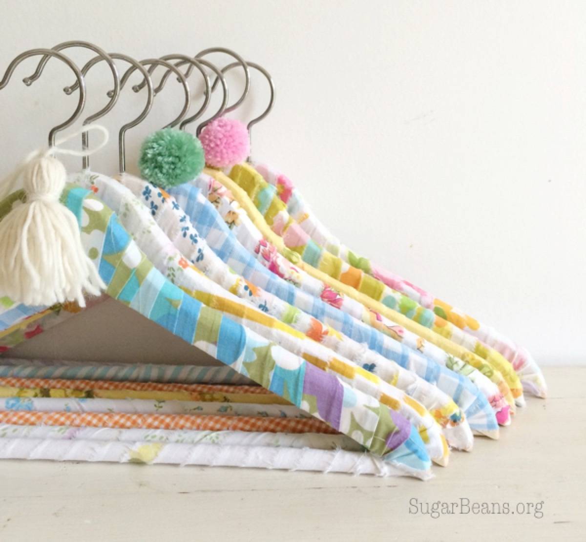 99 ways to use fabric to decorate your home | Wrapped coat hangers