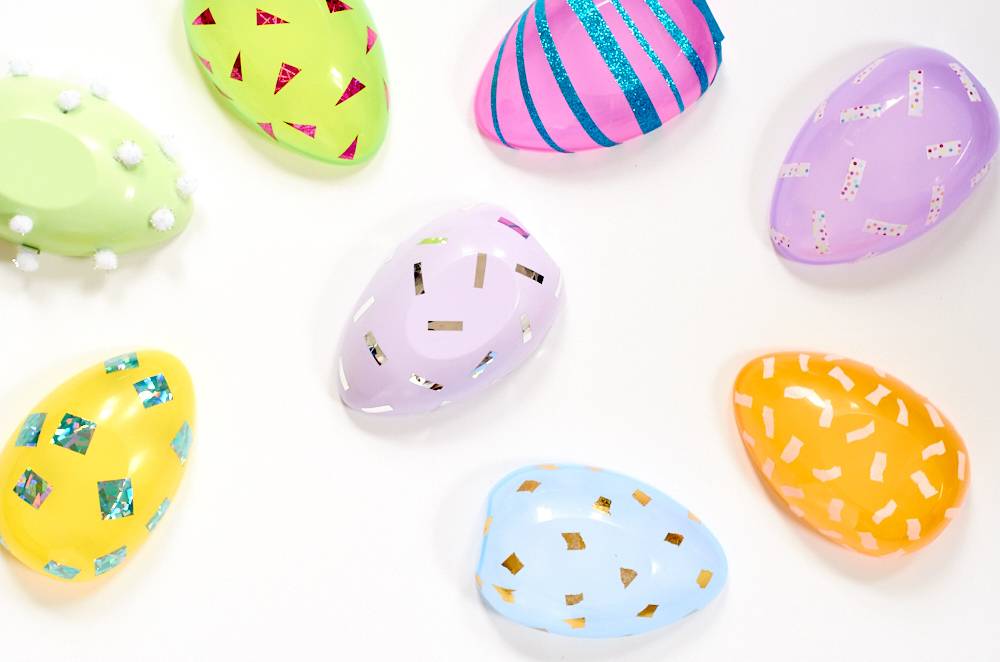 Several multi colored eggs have different designs on them.