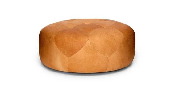 Round brown leather ottoman with tufted top and petal shapes.