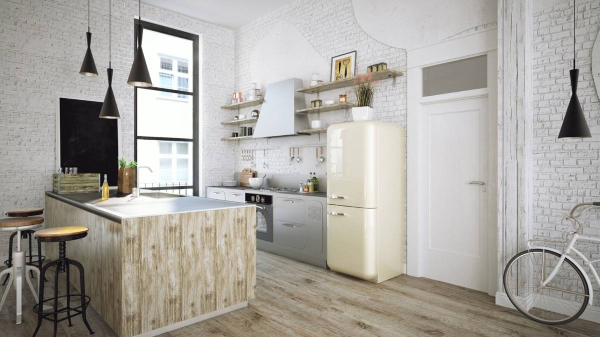 Kitchen along with table, cooking top and refrigerator.