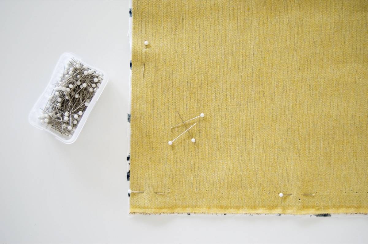 DIY Waterproof Picnic Blanket: Pin cotton fabric to vinyl fabric