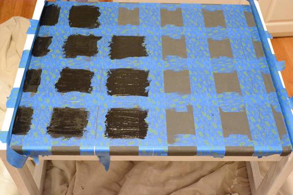 A blue and black grid is made by tape on a surface.