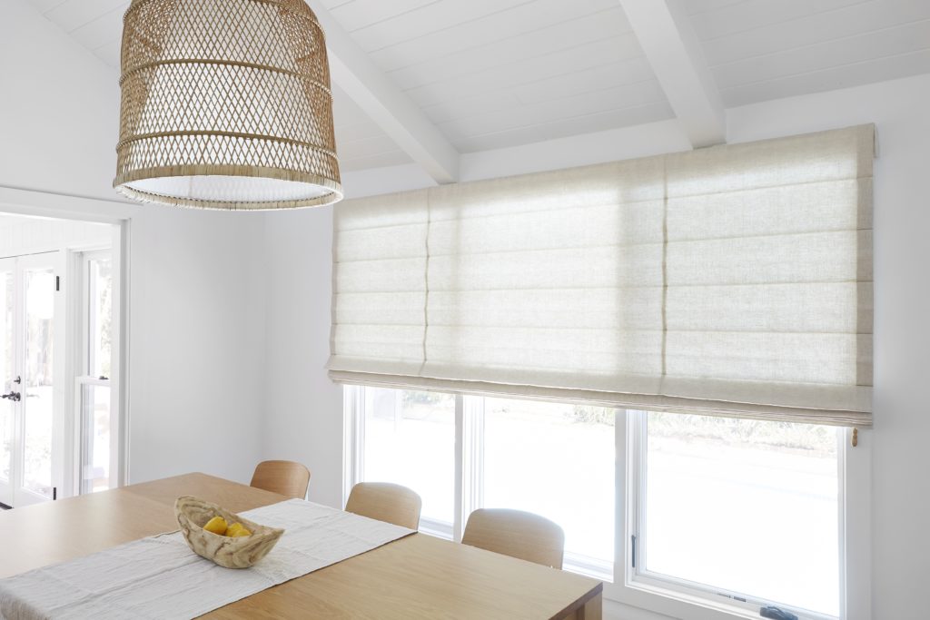 roman shade covering old blinds