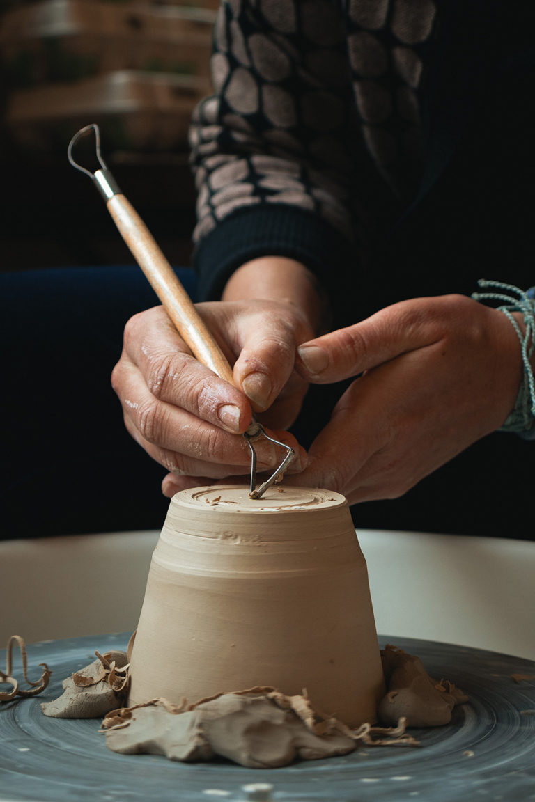 working at a potter's wheel