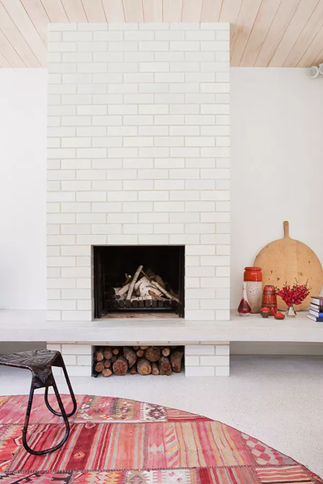 Clean and contemporary white washed brick fireplace from Clare Cousins Architects.