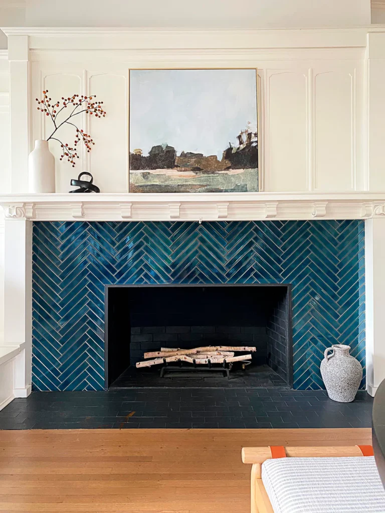 Deep blue herringbone tile fireplace design from REEMS Design