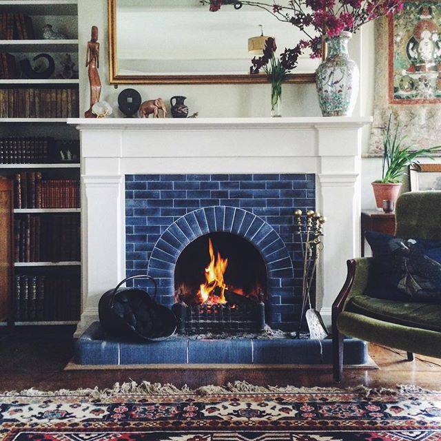 Traditional blue tile fireplace with a simple white mantle for a more modern look. 