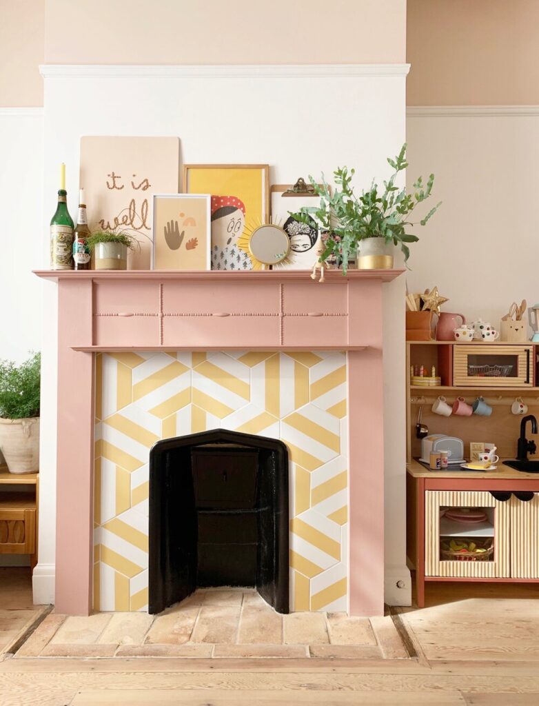 Fun yellow tiles paired with a pink beaded fireplace mantel. 