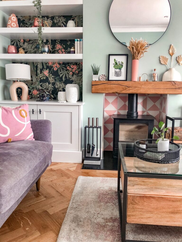 Pink patterned tiles surrounding a traditional wood burning stove.