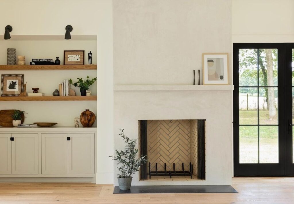 white fireplace with herringbone insert. 