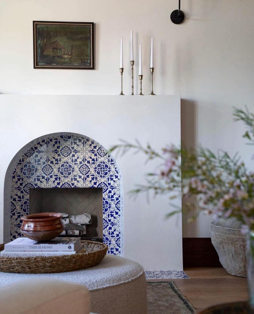 Curved-lines and blue tile work in this Spanish-style home. Modern fireplace ideas.