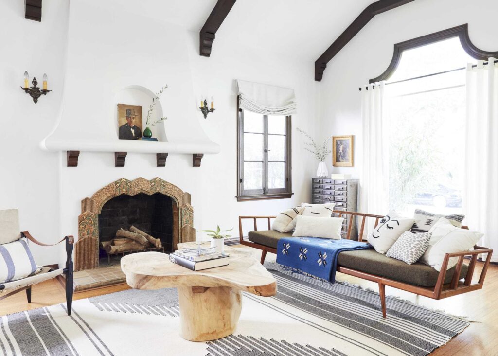 Stunning Spanish-style fireplace makes for a fantastic focal point in this living room. Modern fireplace ideas.