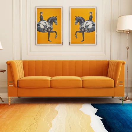 colorful artwork hanging above an orange couch