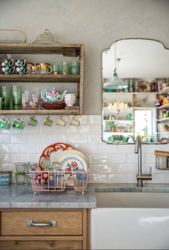 Vintage dishes and mirror complete this cottage core kitchen. Image from The Gardeners House Blog.