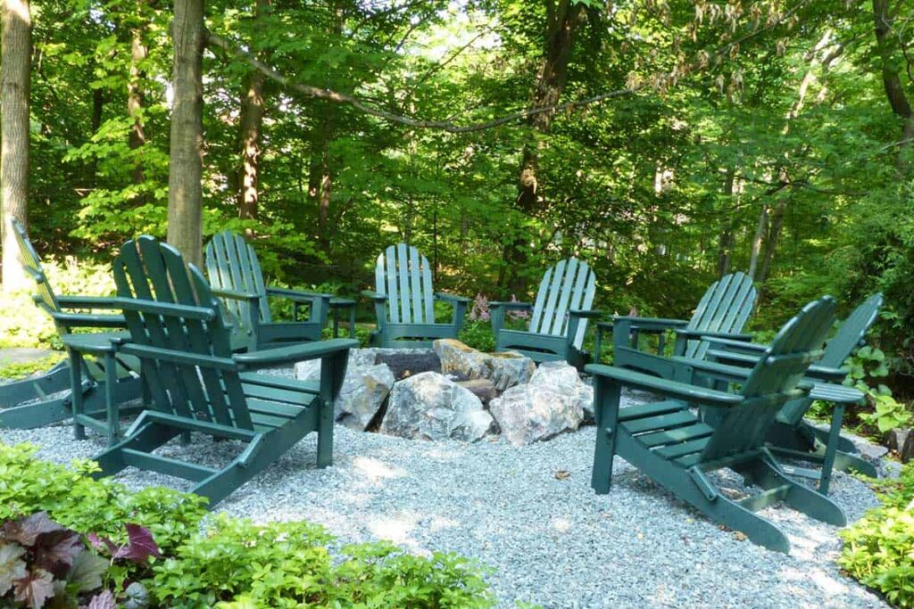 A rustic fire pit surrounded by trees.