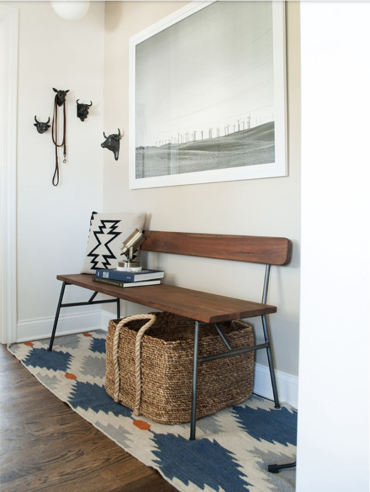 Entryway baskets under a bench to hide your shoe storage.