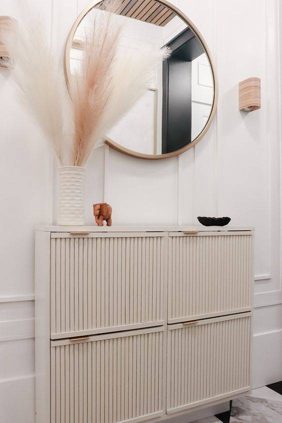 shoe storage cabinet with fluted fronts.