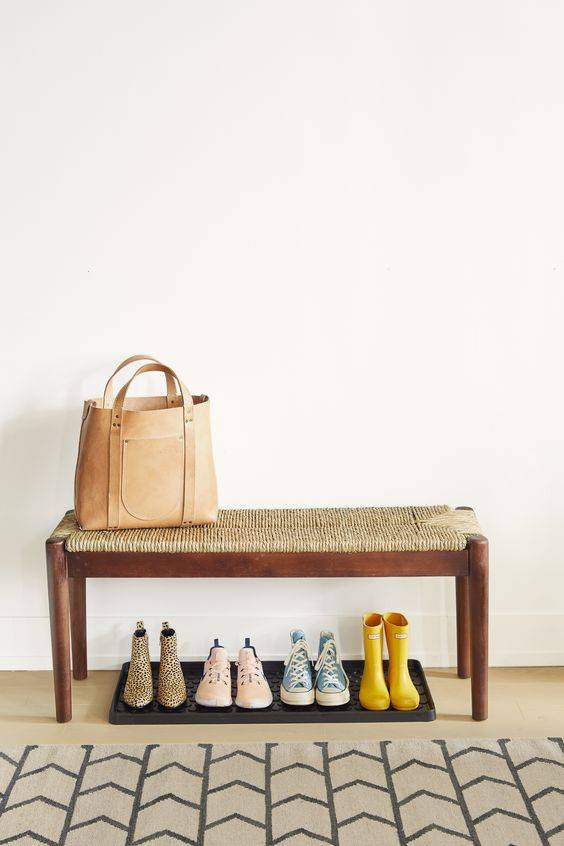 shoe trays under a bench to keep floor clean. 