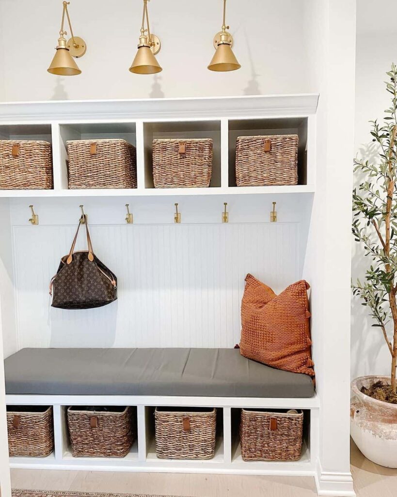 A modern mudroom with a padded bench and storage compartments from Soul and Lane.
