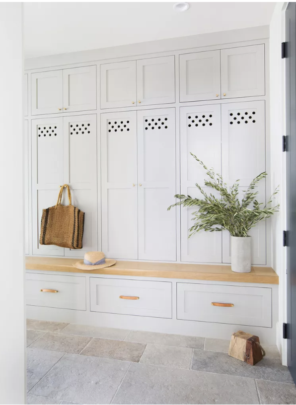 A mudroom bench with storage drawers underneath from The Spruce.
