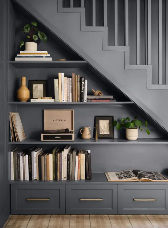 Shoe storage drawers combined with  bookshelves in this storage solution from Magnolia. 