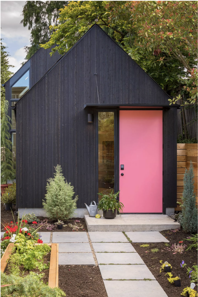 We love the combo of the black exterior with the pop of the pink door. Paint color is Benjamin Moore's Flamingo's Dream.