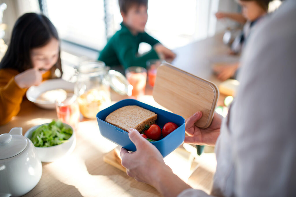 small bento box with kids in the background