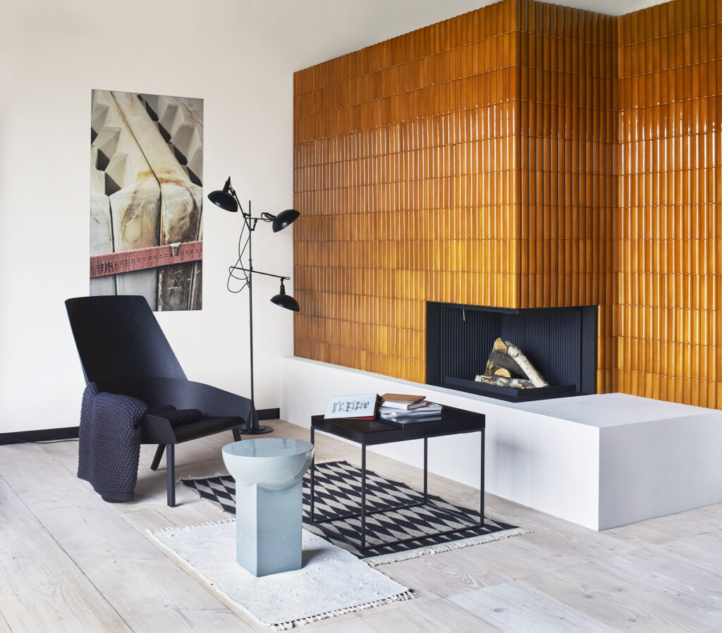 Orange geometric two-sided tiled midcentury fireplace.