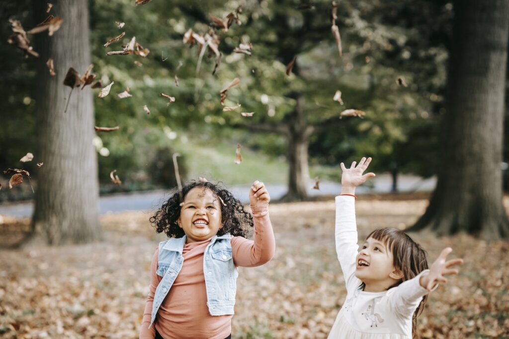 Kids tossing leaves in the air