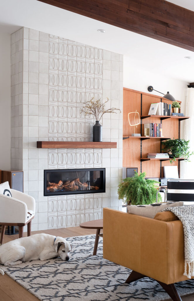 Geometric tiles paired with a minimalist mantel in this perfect midcentury living space.