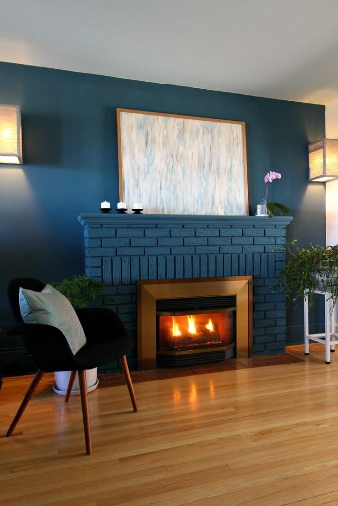 Coastal blue painted brick fireplace in living room with chair 