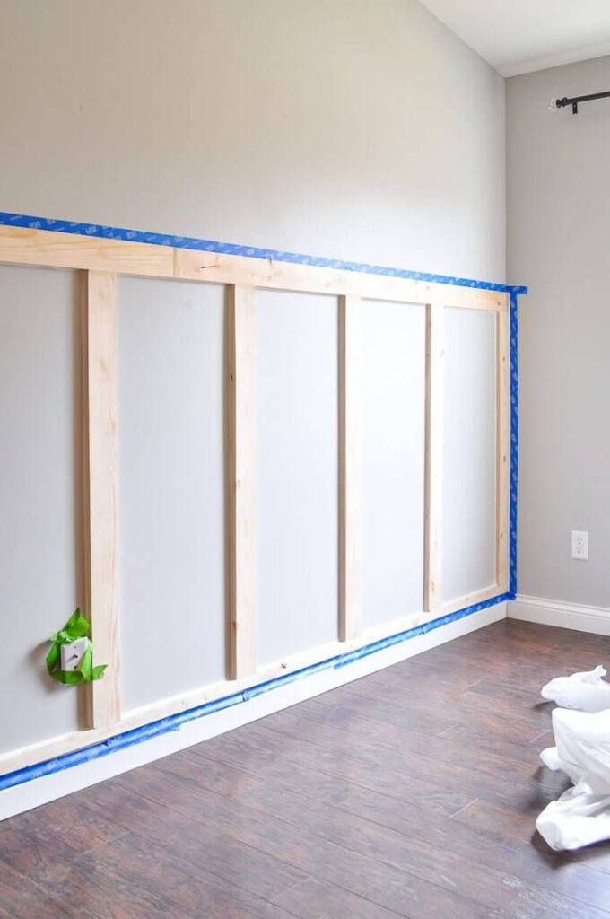 DIY board and batten wainscoting, white, with blue tape