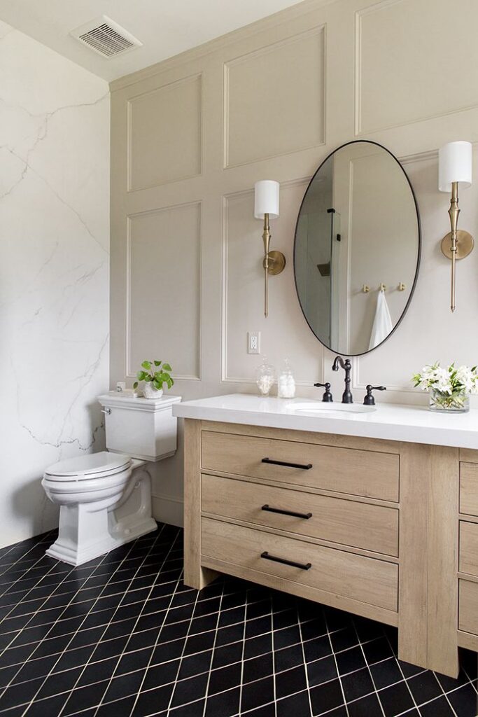 Recessed panel wainscoting white in bathroom with beige counter and circle mirror