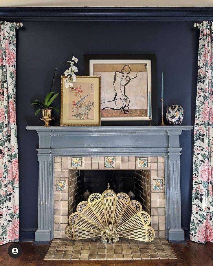 Blue and beige brick fireplace with golden peacock in pit