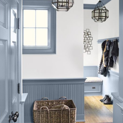 Blue entryway wainscoting and wicker basket