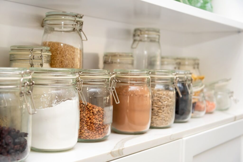 a row of jars filled with different types of food