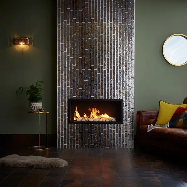 Silver fireplace with lit fire in dark room
