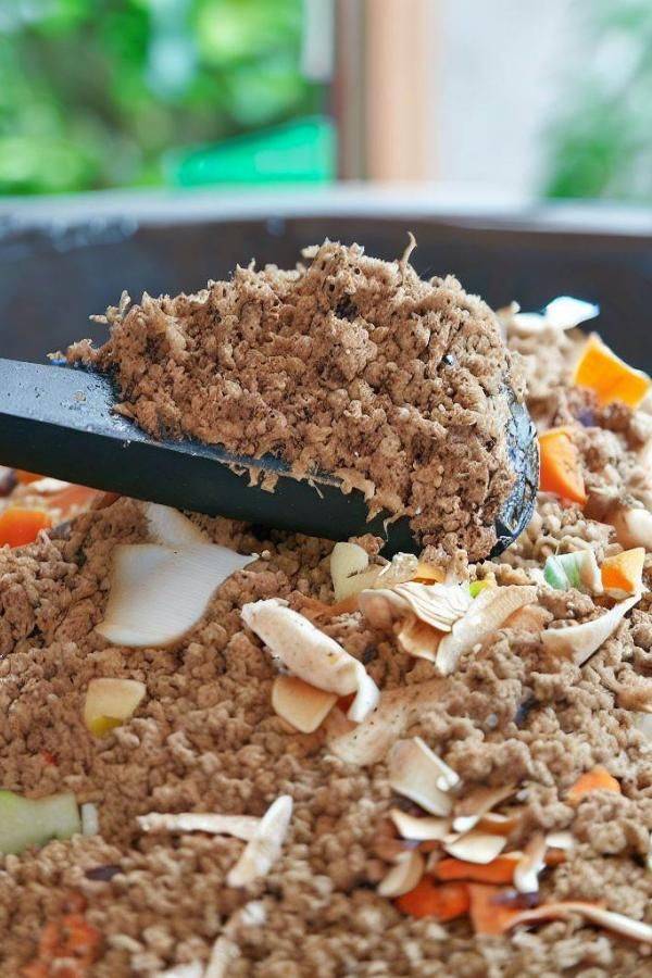 Bokashi compost with wooden spoon