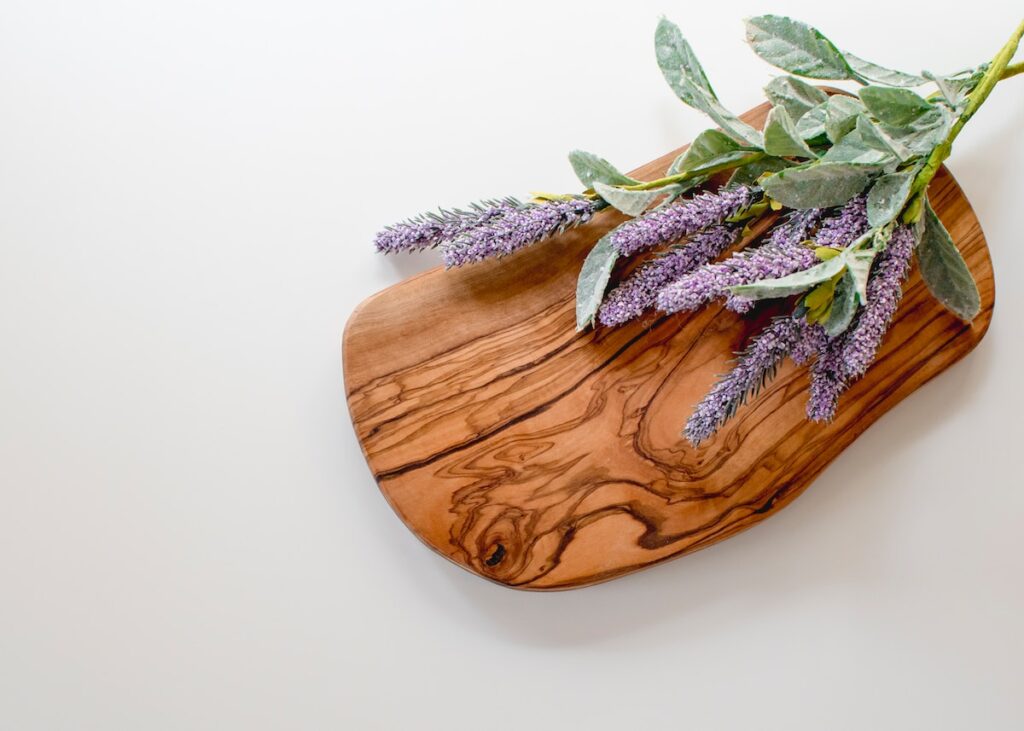 green and purple leaves on brown wooden chopping board