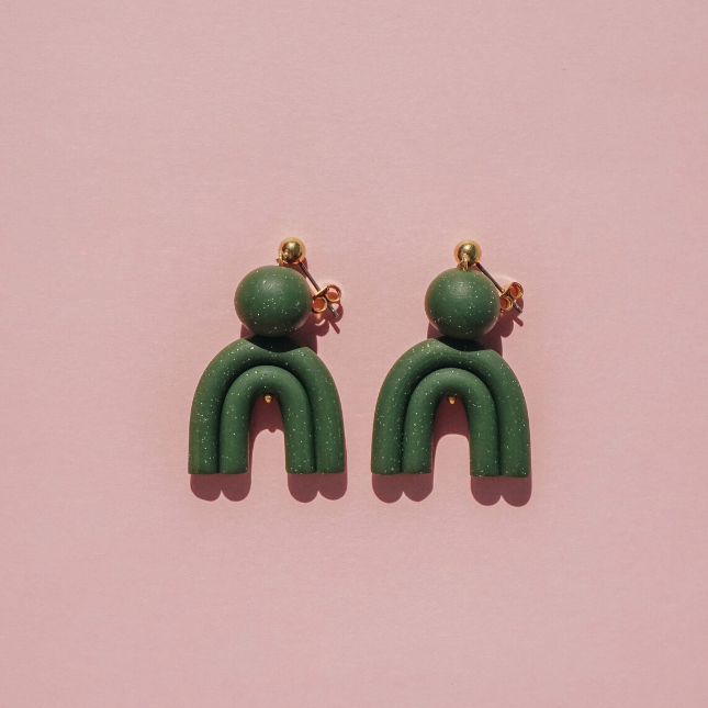 arch shaped green earrings.