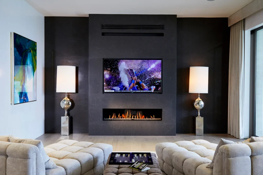 Black wall in living room with fireplace and tv