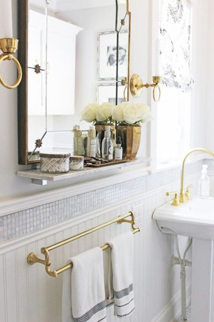 Cream wall in bathroom with mosaic wainscoting tile over sink