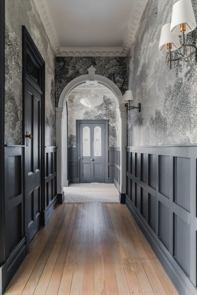 Black wainscoting along entryway of home 