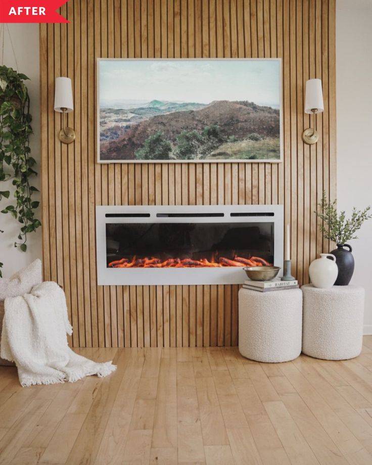 Wood wall with cut pieces and electric fireplace with a painting above