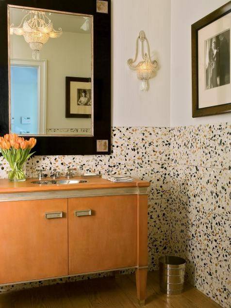 Terrazzo wainscoting in bathroom with cream wall and orange sink
