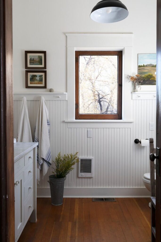 White farmhouse bathroom with brown window