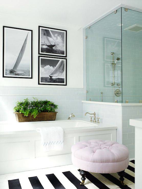 Glass shower door in white bathroom