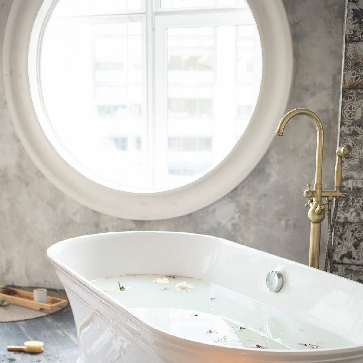 modern bathtub filled with water for bathroom window privacy ideas