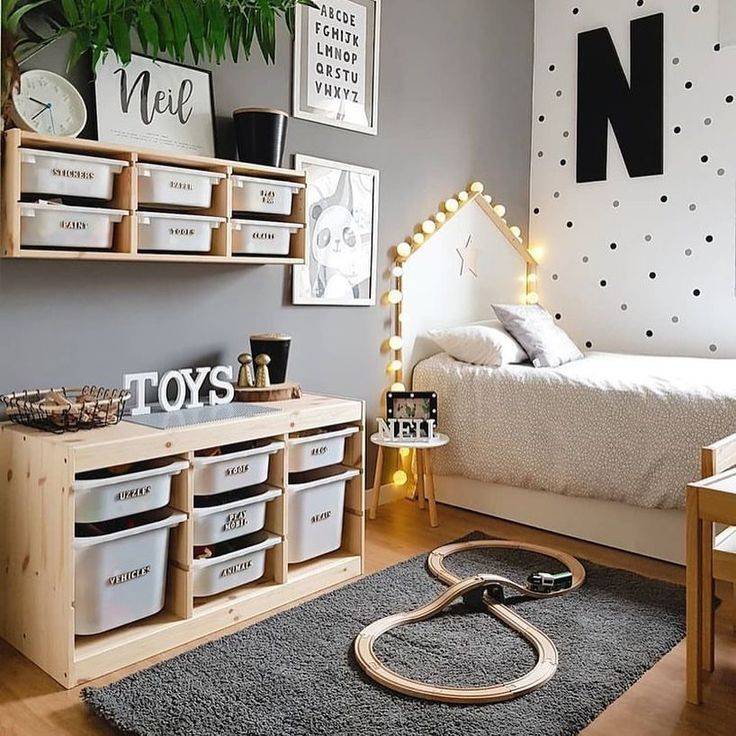 White kids bed with a beige storage shelf and grey rug