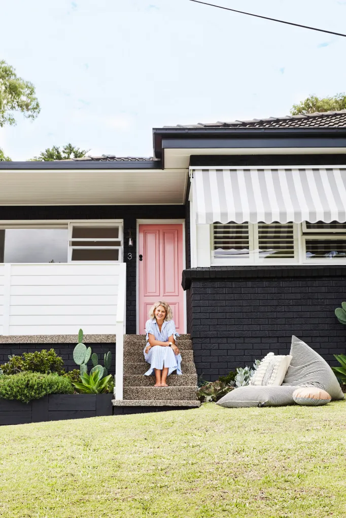 Painted red bricks and a bright pink door breathe new life into this home exterior